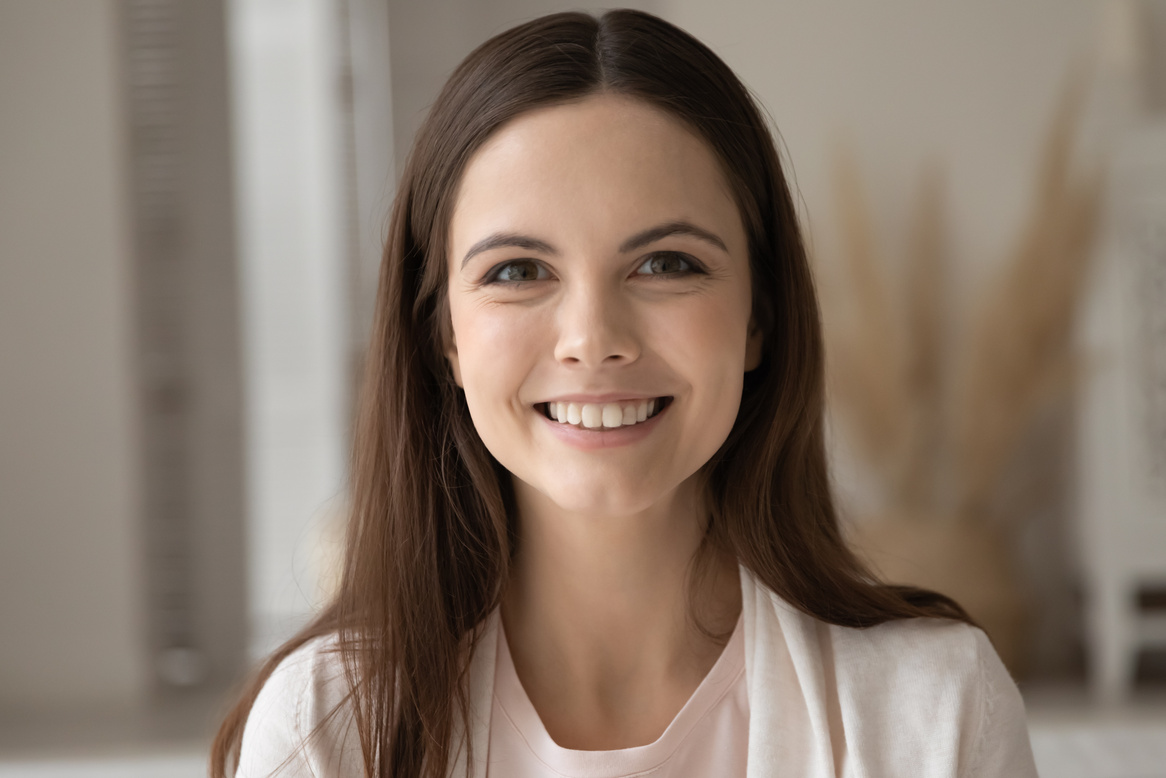 Profile picture of pretty smiling young woman posing indoors